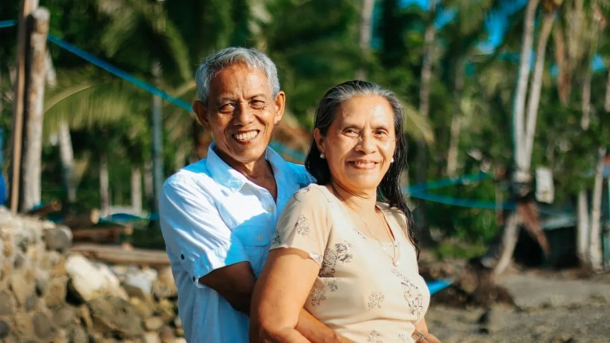 Happy active retired couple enjoying the coast