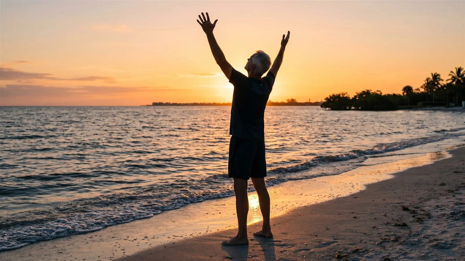 Athletic man standing tall on the beach at sunrise, stretching his back pain-free